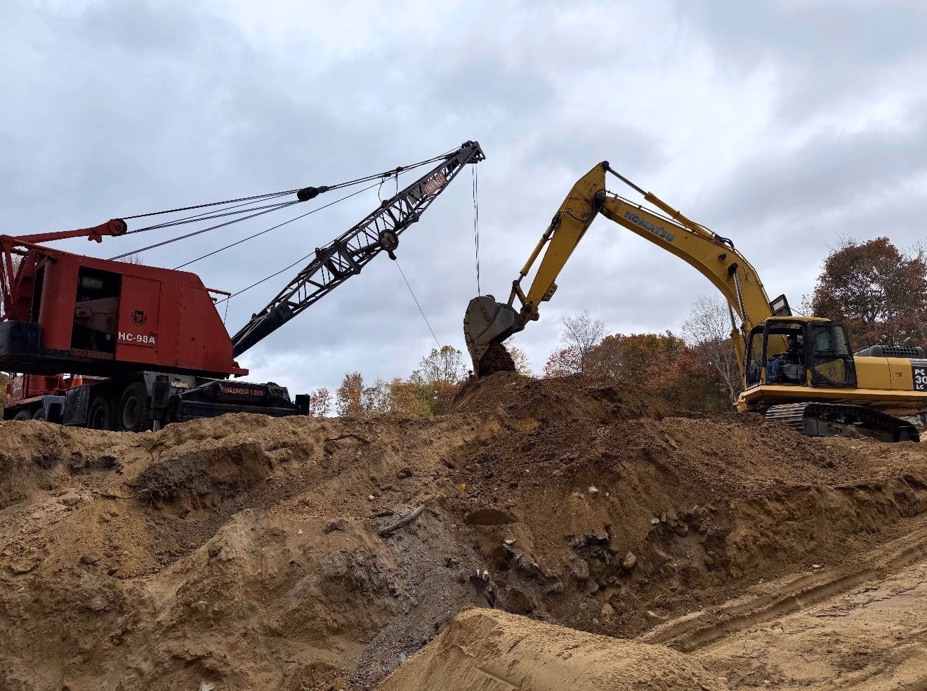 D.C. Crane Service — crane and excavator on a deep residential dig, Long Island NY