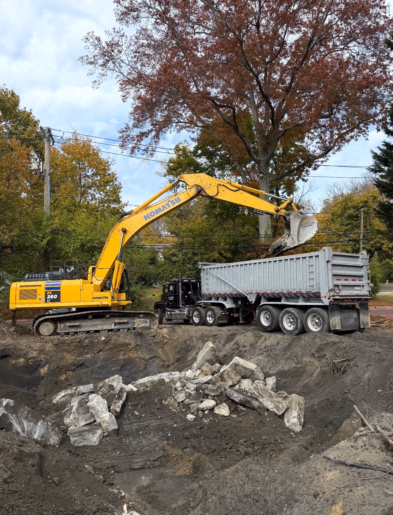D.C. Crane Service — excavator loading demolition debris